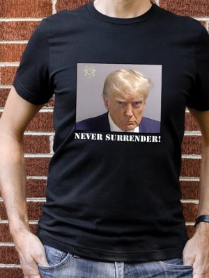 Never Surrender T Shirt Never Surrender Merchandise Trump Mugshot Merchandise Trump Mug Shot Merchandise Donald Trump Merchandise Trump T Shirts Donald Trump Mugshot Shirt revetee.com 2