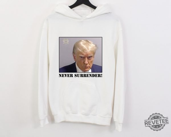 Trump Never Surrender Hoodie Never Surrender T Shirt Never Surrender Merchandise Trump Mugshot Merchandise Trump Mug Shot Merchandise Donald Trump Merchandise Unique revetee.com 1