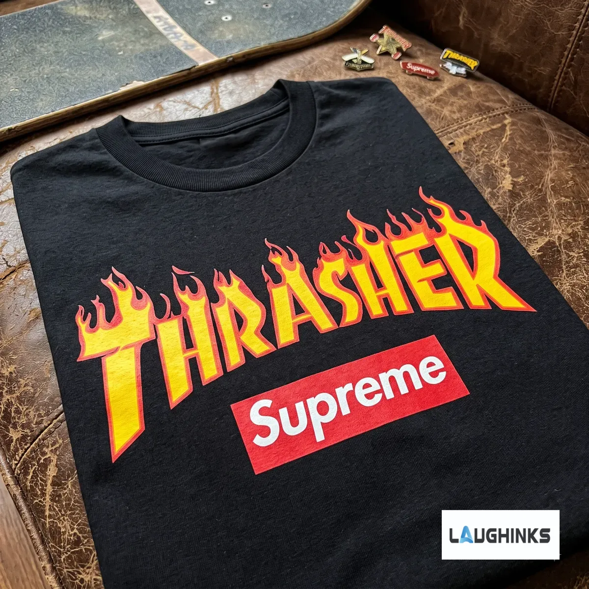 Thrasher x Supreme Flame Logo Graphic T-shirt 2026 4 Detailed front view of the black Thrasher x Supreme collaboration flame logo t-shirt on a leather background.